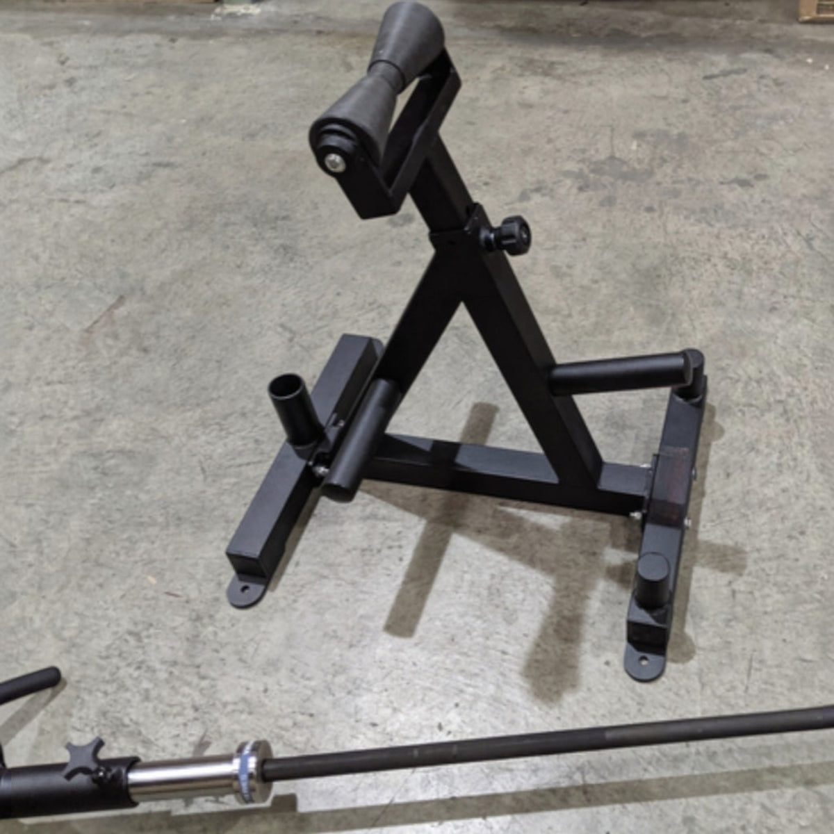 Gymless landmine stand with nylon roller, barbell holder, and three plate storage poles for strength training.