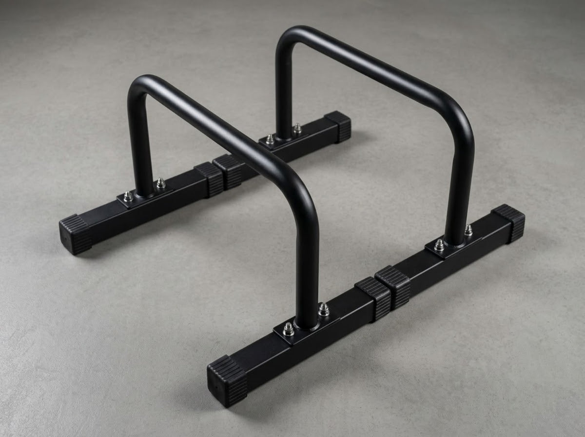 Angled view of a pair of black Gymless parallettes on a grey background.