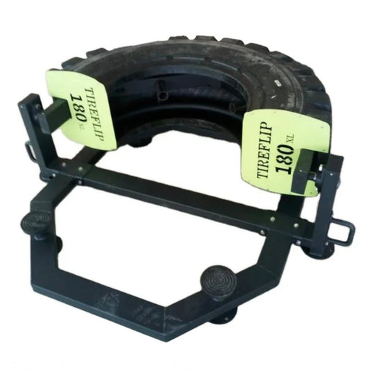 Gymless TyreFlip 180 XL fitness machine with a black rubber tyre and light green weight plates for strength training